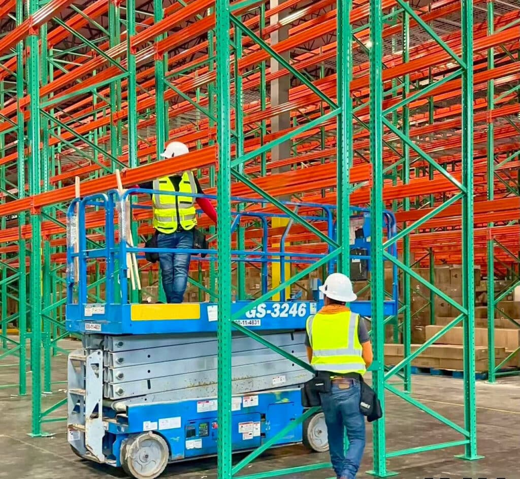 two IMH workers assembling pallet racks in a new warehouse
