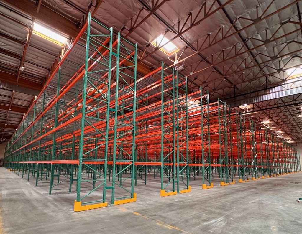 Selective Pallet Racks Green and orange pallet racks in a warehouse