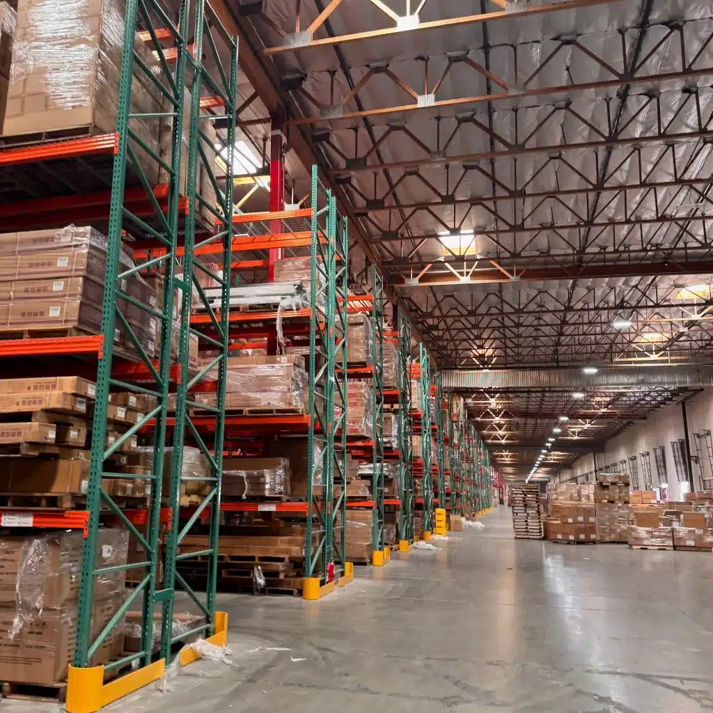 High-capacity pallet racking filled with boxed consumer goods in a CPG and DTC distribution warehouse in California