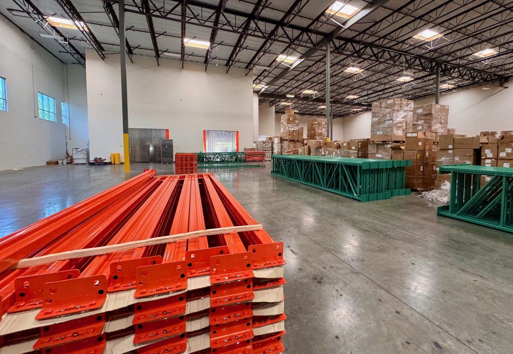 Pallet rack components delivered to a California warehouse before installation, showing early stages of a warehouse racking project