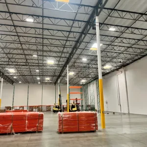 IMH Group installation crew setting uprights and beams during pallet rack installation for Primax Wheels in Ontario, California.