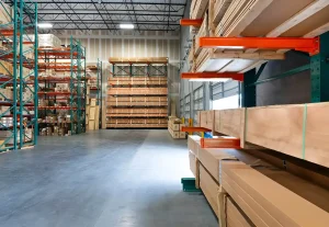 Cantilever racking loaded with lumber inside a Fontana, CA warehouse, designed for storing long and heavy building materials.